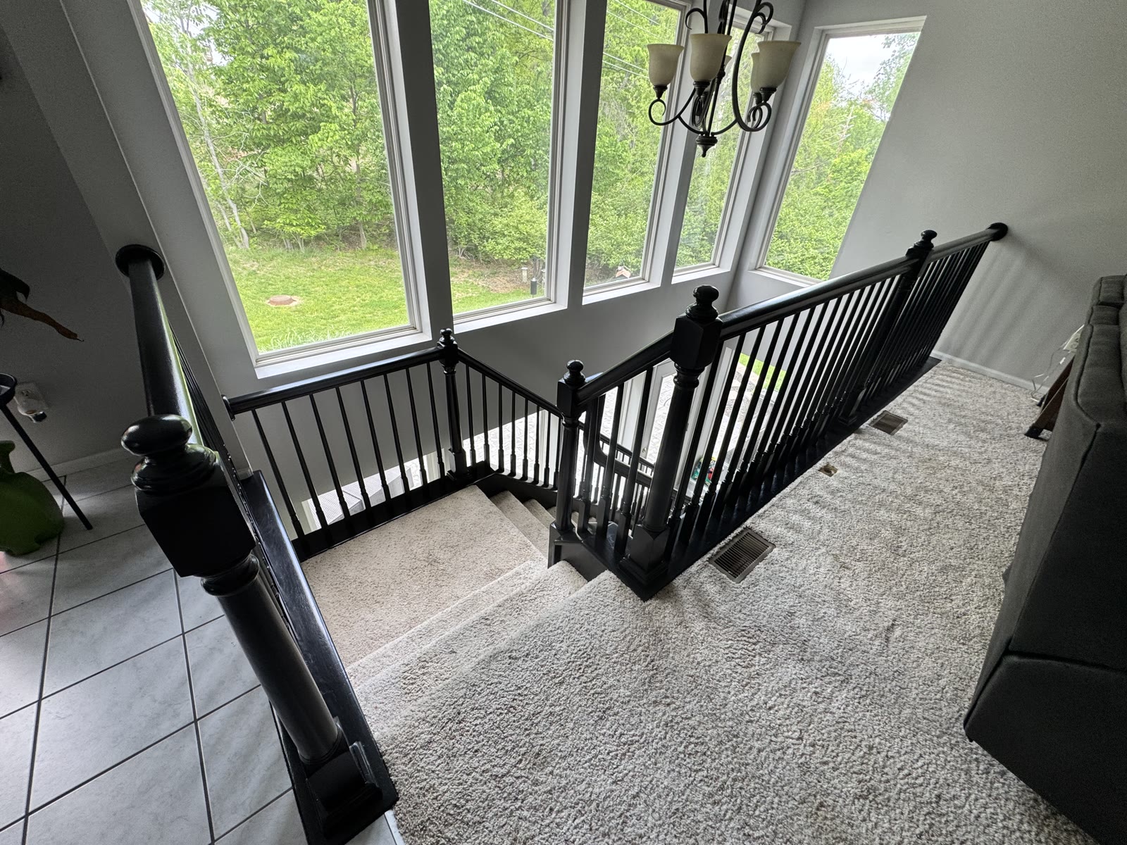 Completed staircase remodel with black iron railing